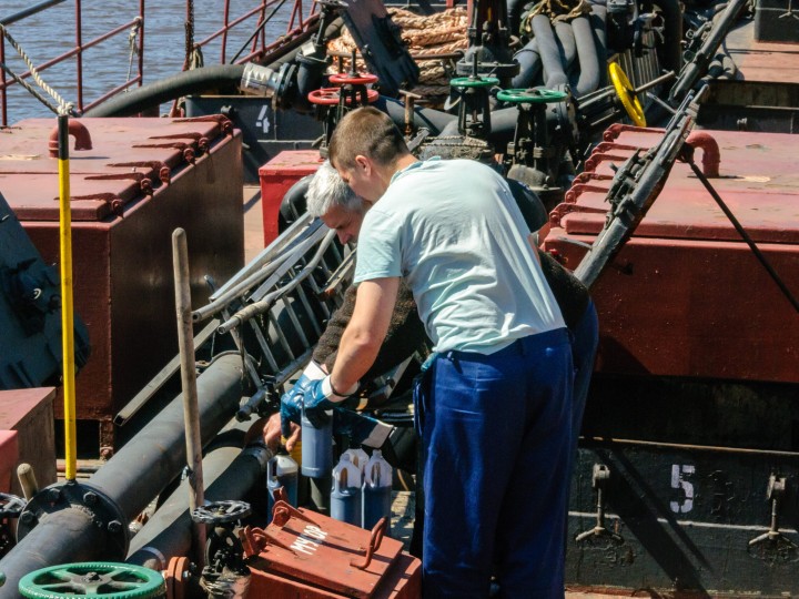 Russia, Saint Petersburg, May 2021: Two male sailors work on the deck of an oil tanker